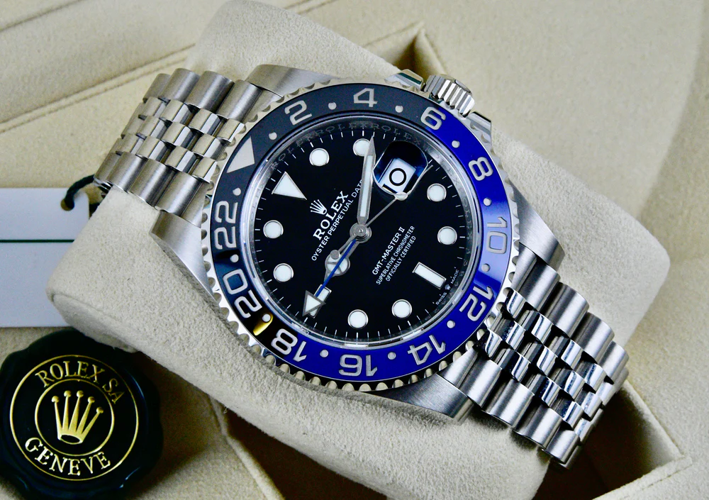 A Rolex GMT-Master II Batman watch with a black dial and blue Cerachrom bezel